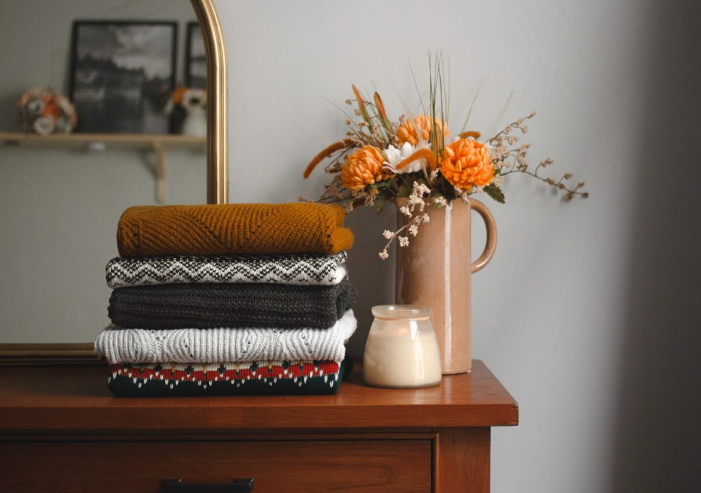 Stack of sweaters on dresser